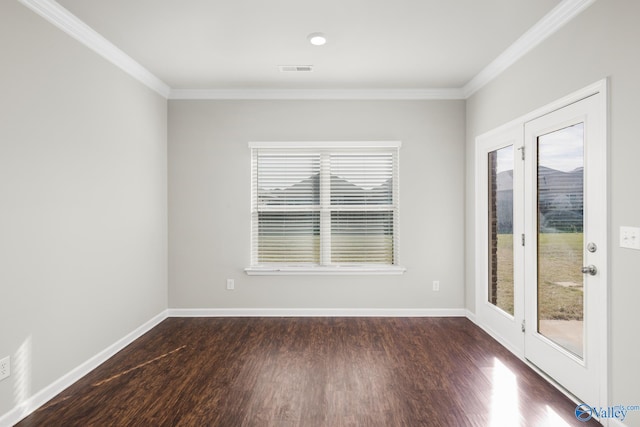 empty room featuring dark hardwood / wood-style flooring and crown molding