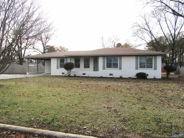 ranch-style house featuring a front lawn and a carport