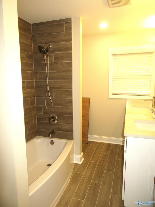 bathroom with vanity and tiled shower / bath combo