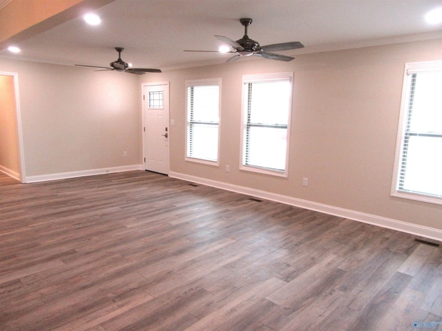 spare room featuring dark hardwood / wood-style floors, ceiling fan, and crown molding