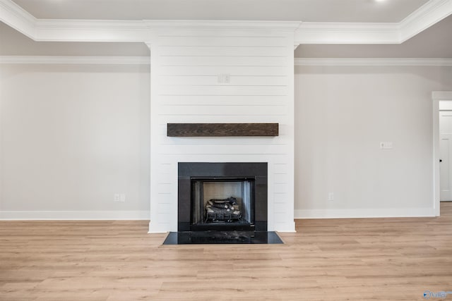 unfurnished living room with a fireplace, light hardwood / wood-style flooring, and crown molding