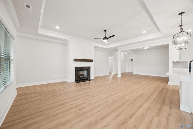 21837 Natures Cove Dr, Athens, AL 35613 - unfurnished living room featuring ceiling fan, light wood-style flooring, recessed lighting, a raised ceiling, and a large fireplace