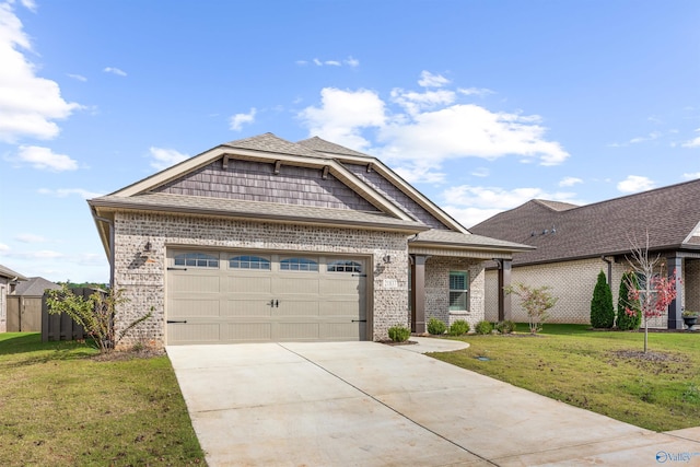 view of front of property with a garage and a front lawn