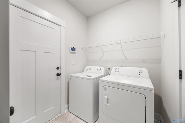 clothes washing area featuring separate washer and dryer