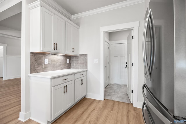 21837 Natures Cove Dr, Athens, AL 35613 - kitchen with freestanding refrigerator, crown molding, light wood finished floors, decorative backsplash, and light countertops
