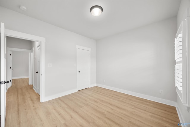 unfurnished bedroom featuring a closet and light hardwood / wood-style flooring