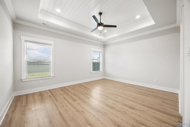 spare room with ornamental molding, a raised ceiling, wood ceiling, light hardwood / wood-style floors, and ceiling fan