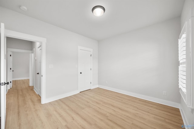 21837 Natures Cove Dr, Athens, AL 35613 - unfurnished bedroom featuring light wood finished floors and baseboards