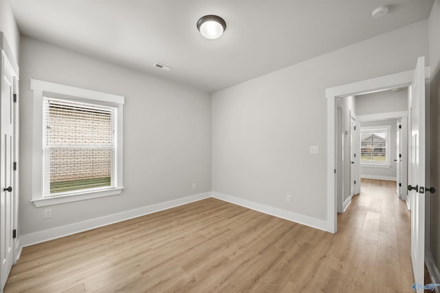 21837 Natures Cove Dr, Athens, AL 35613 - empty room with light wood-type flooring, baseboards, and a smoke detector