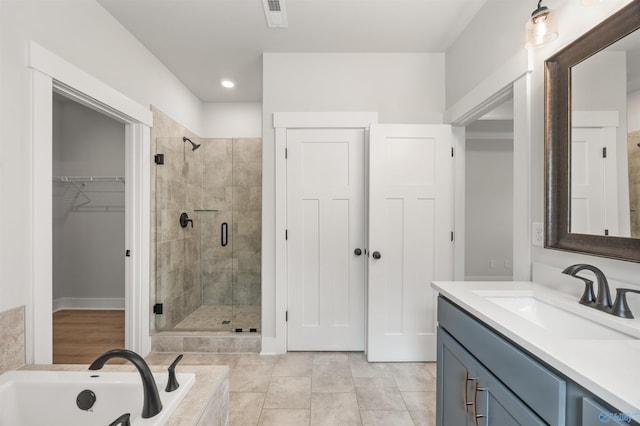 bathroom with vanity, plus walk in shower, and tile patterned floors