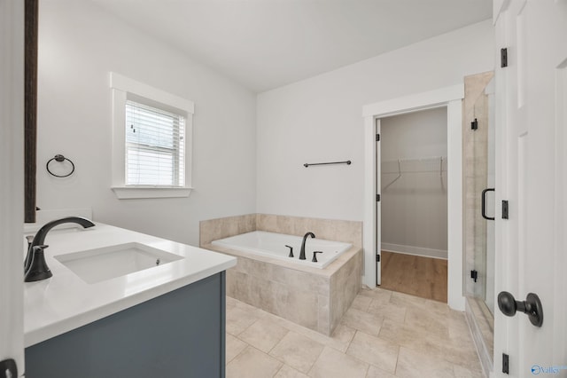 21837 Natures Cove Dr, Athens, AL 35613 - full bathroom featuring a shower stall, a bath, a walk in closet, and double vanity