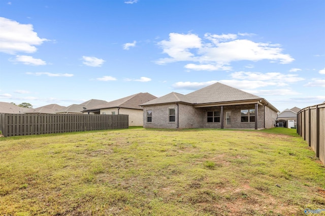 rear view of property with a yard