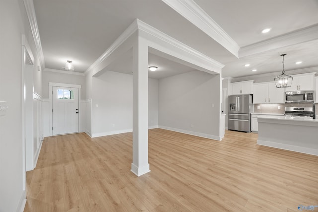 interior space featuring light wood-type flooring and ornamental molding