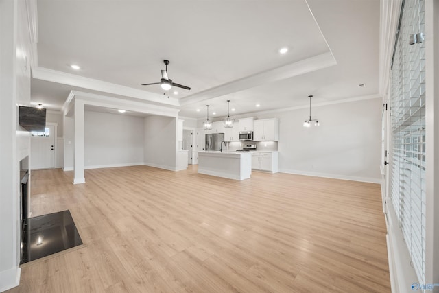 21837 Natures Cove Dr, Athens, AL 35613 - unfurnished living room featuring ceiling fan, baseboards, ornamental molding, a fireplace, and light wood-type flooring
