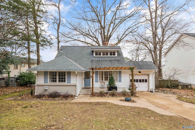 front facade featuring covered porch, a front yard, and a garage