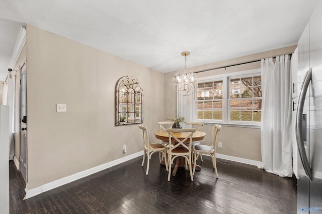 dining area featuring a chandelier and dark hardwood / wood-style floors