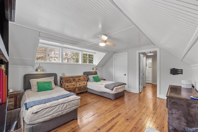 bedroom with ceiling fan, light hardwood / wood-style flooring, and lofted ceiling