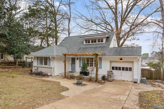 view of front of house with central AC, a front lawn, and a garage