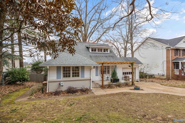 view of front of home with a garage and a front lawn