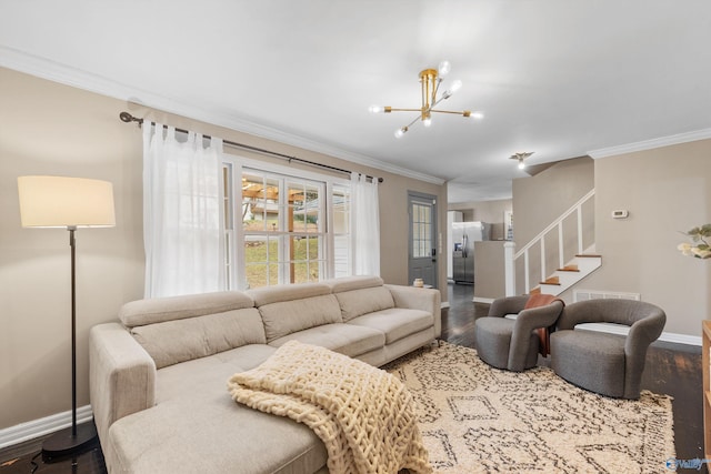 living room with wood-type flooring, ornamental molding, and a notable chandelier