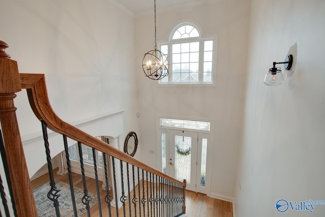 entrance foyer featuring an inviting chandelier and wood-type flooring