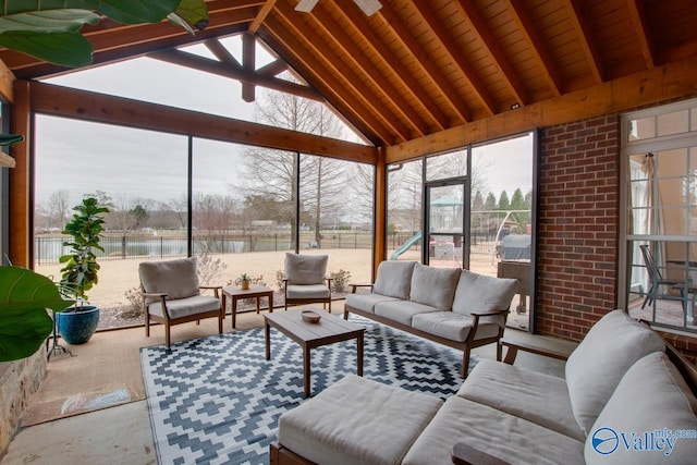 sunroom featuring a water view and vaulted ceiling with beams