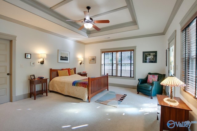 carpeted bedroom with crown molding, ceiling fan, and a raised ceiling