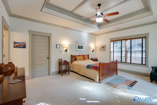 bedroom featuring a raised ceiling, crown molding, light carpet, and ceiling fan