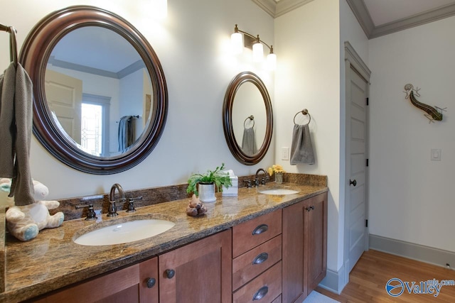 bathroom featuring vanity, hardwood / wood-style floors, and ornamental molding