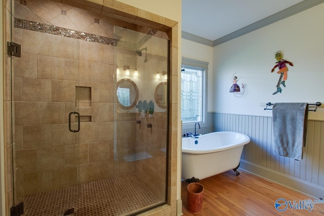 bathroom featuring crown molding, wood-type flooring, and plus walk in shower