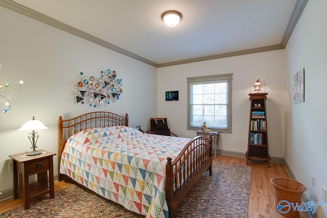 bedroom featuring hardwood / wood-style floors and ornamental molding