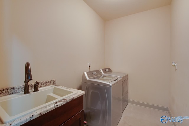 laundry area with washer and clothes dryer and sink