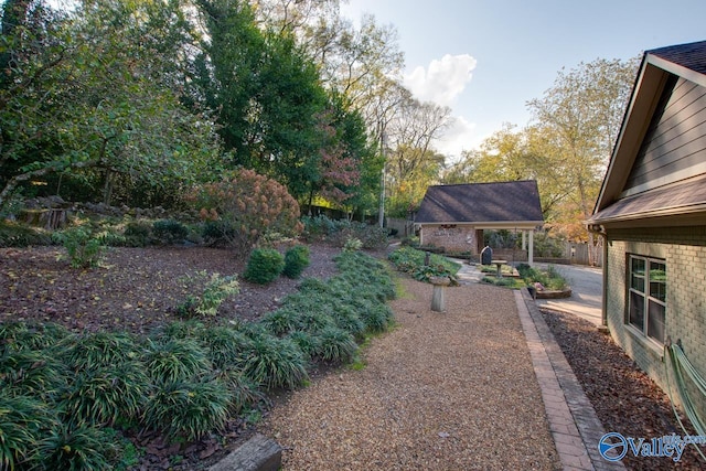 view of yard featuring a patio and an outbuilding