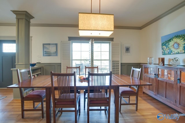 dining area with crown molding, plenty of natural light, and ornate columns