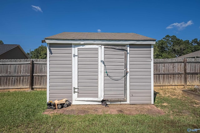 view of outbuilding featuring a lawn