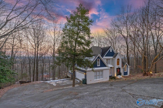 property exterior at dusk featuring a garage