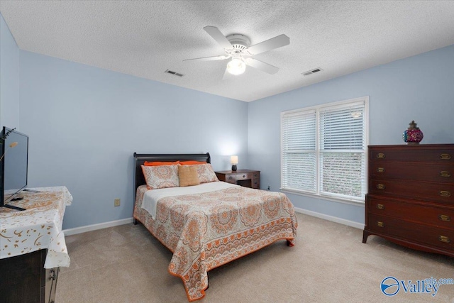 carpeted bedroom with a textured ceiling and ceiling fan