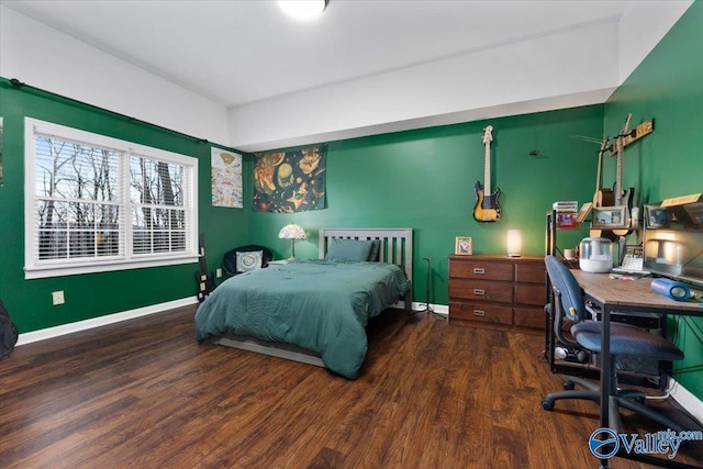 bedroom with dark hardwood / wood-style flooring