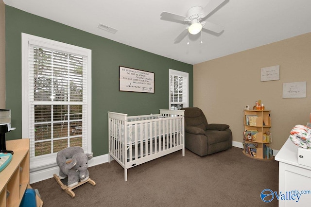 899 Pine Grove Rd, Harvest, AL 35749 - bedroom featuring ceiling fan, visible vents, baseboards, a crib, and dark carpet