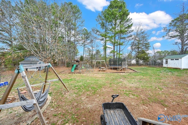 899 Pine Grove Rd, Harvest, AL 35749 - view of yard with a trampoline, an outbuilding, a playground, fence, and a shed