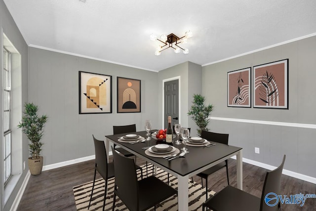 1007 Honeysuckle Ln SW, Decatur, AL 35601 - dining area with wood finished floors, baseboards, a chandelier, a decorative wall, and ornamental molding