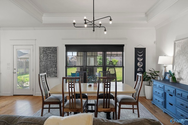 24673 Beacon Cir, Athens, AL 35613 - dining area with a tray ceiling, wood finished floors, a chandelier, crown molding, and baseboards