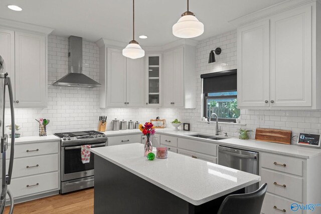 24673 Beacon Cir, Athens, AL 35613 - kitchen featuring stainless steel appliances, wall chimney exhaust hood, a sink, backsplash, and recessed lighting