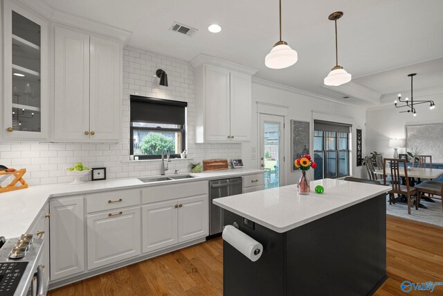 24673 Beacon Cir, Athens, AL 35613 - kitchen with a sink, stainless steel appliances, light wood-style flooring, decorative backsplash, and white cabinets