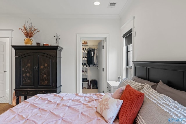 24673 Beacon Cir, Athens, AL 35613 - bedroom with a walk in closet, ornamental molding, a closet, wood finished floors, and recessed lighting
