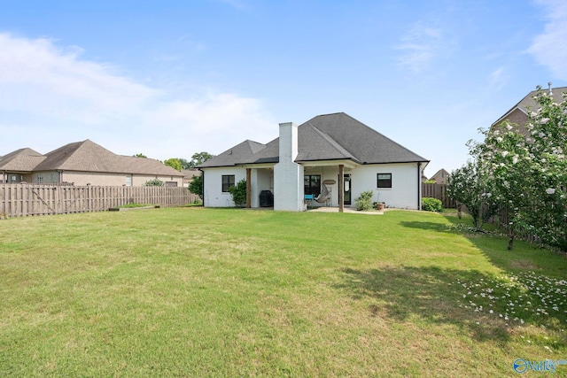 24673 Beacon Cir, Athens, AL 35613 - back of house with a chimney and a patio