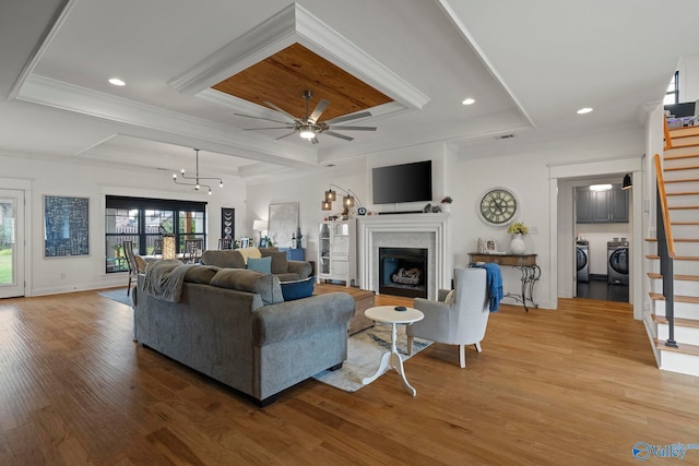 24673 Beacon Cir, Athens, AL 35613 - living room featuring stairway, washing machine and clothes dryer, a fireplace, ceiling fan, and wood finished floors