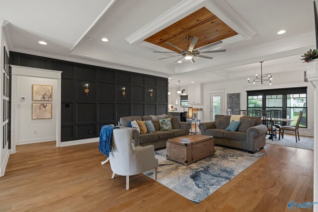 24673 Beacon Cir, Athens, AL 35613 - living area with ornamental molding, a decorative wall, ceiling fan, a chandelier, and light wood-style flooring