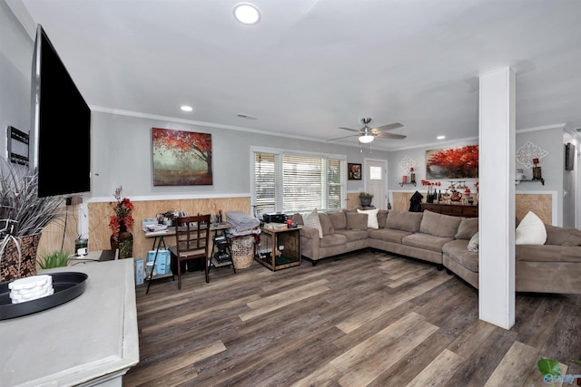 living room with ceiling fan, dark hardwood / wood-style flooring, wooden walls, and ornamental molding