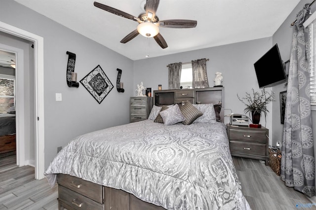 bedroom with ceiling fan and light wood-type flooring